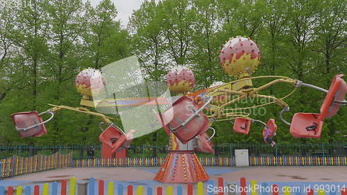 Image of MOSCOW, RUSSIA, May 21, 2017: Children go in carousel and having fun on a cloudy day, Moscow.