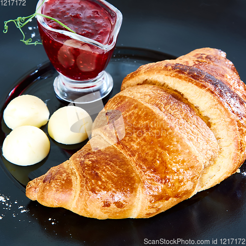 Image of Closeup of butter, jam and fresh croissants