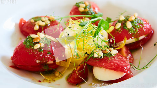 Image of Mozzarella and tomato salad - caprese on the white plate. Shallow dof