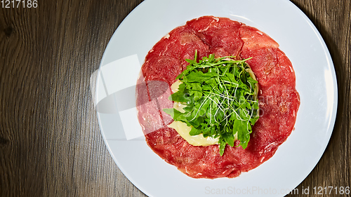 Image of The meat carpaccio with salad. Shallow dof.