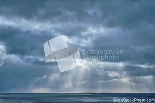 Image of Norwegian sea in winter with sun rays