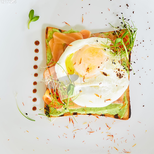 Image of Egg benedict with hollandaise sauce and smoked salmon on toast. Delicious breakfast.