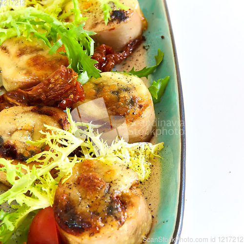 Image of Fried scallops with butter lemon spicy sauce served with green salad. Top view, copy space.