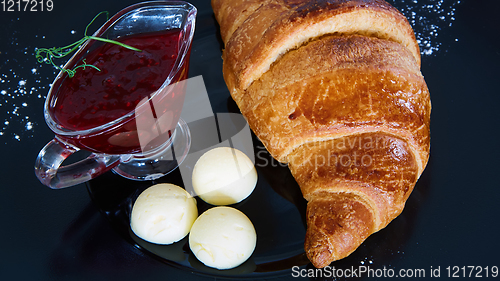 Image of Closeup of butter, jam and fresh croissants