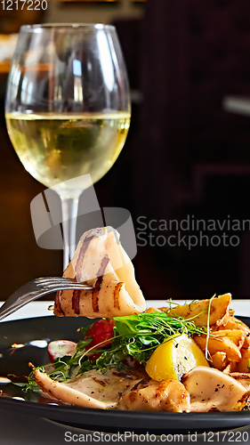 Image of The grilled squid with salad. Shallow dof.