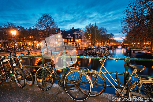 Image of Amterdam canal, bridge and medieval houses in the evening