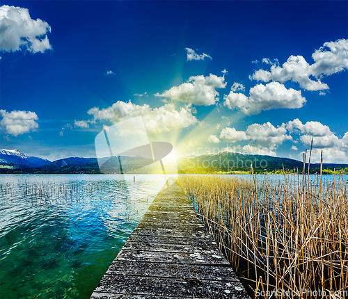 Image of Pier in the lake, countryside on sunset
