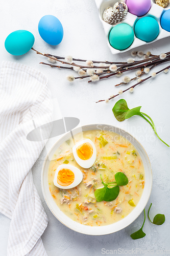 Image of Traditional Polish sour soup Zurek in ceramic bowl  for Easter