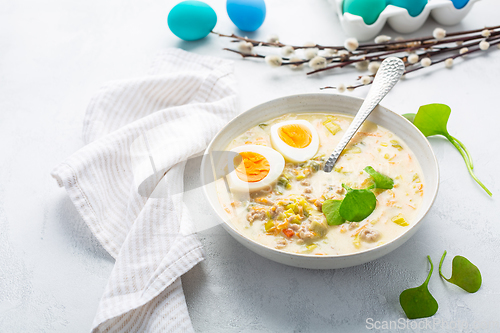 Image of Traditional Polish sour soup Zurek in ceramic bowl  for Easter