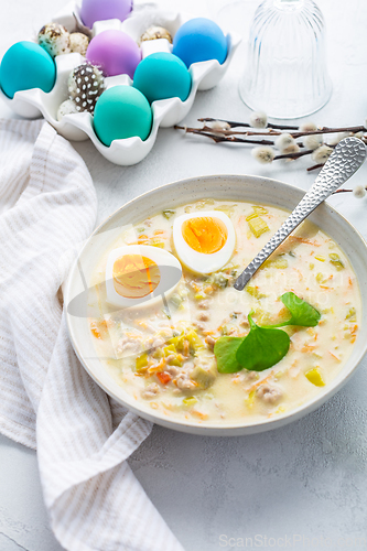 Image of Traditional Polish sour soup Zurek in ceramic bowl  for Easter