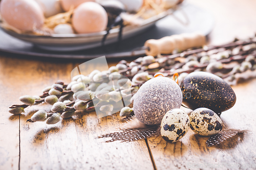 Image of Easter eggs with pussy-willow branch on wooden kitchen table