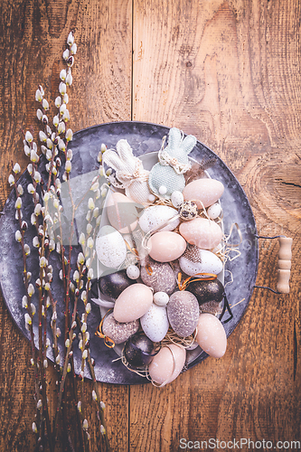 Image of Easter eggs with pussy-willow branch on wooden kitchen table