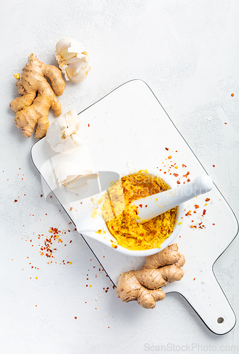 Image of Homemade Fresh Ginger and Garlic paste or Adrak Lahsun puree in ceramic bowl