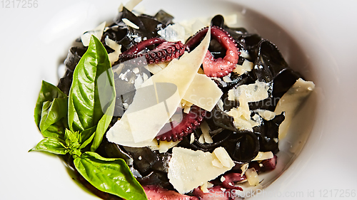 Image of Pasta with black cuttlefish ink, octopuses and parmesan.