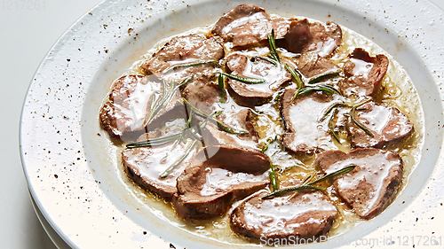 Image of Fried beef tongue with coarse salt. Grilled beef tongue.