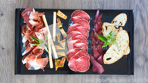 Image of Antipasto Platter Cold meat plate with grissini breadsticks.