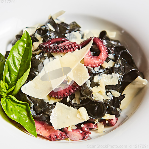 Image of Pasta with black cuttlefish ink, octopuses and parmesan.