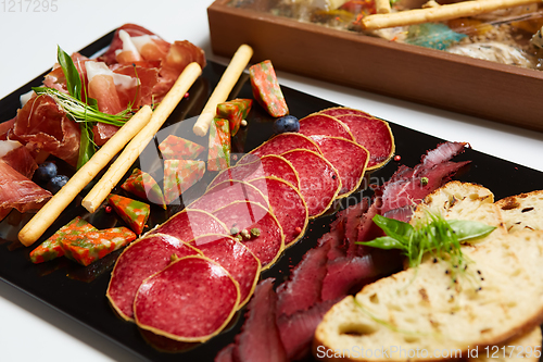 Image of Antipasto Platter Cold meat plate with grissini breadsticks.