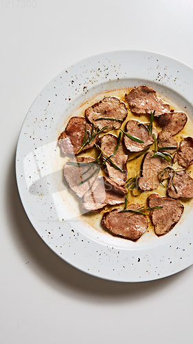 Image of Fried beef tongue with coarse salt. Grilled beef tongue.