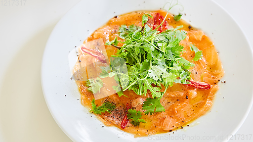 Image of Top view of salmon carpaccio. Shallow dof.