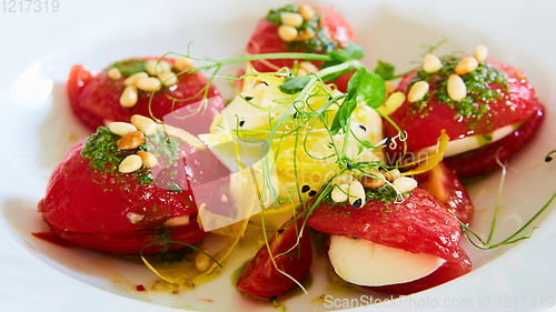 Image of Mozzarella and tomato salad - caprese on the white plate. Shallow dof