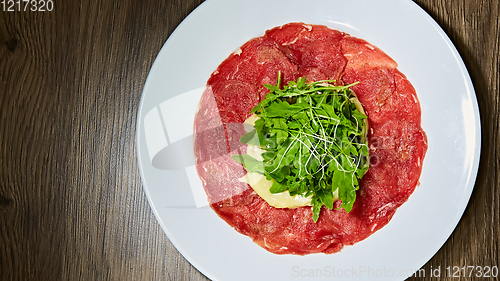 Image of The meat carpaccio with salad. Shallow dof.