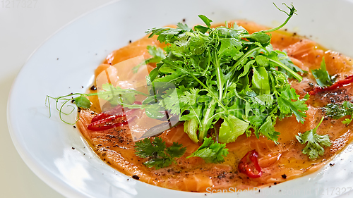 Image of Top view of salmon carpaccio. Shallow dof.