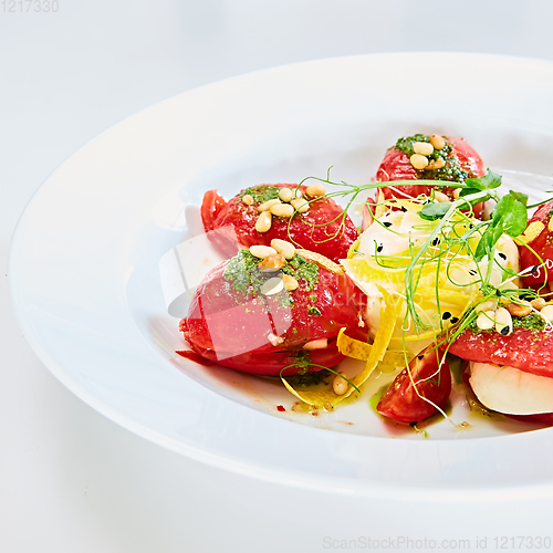 Image of Mozzarella and tomato salad - caprese on the white plate. Shallow dof