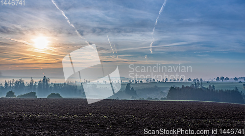 Image of Autumn foggy and misty sunrise landscape