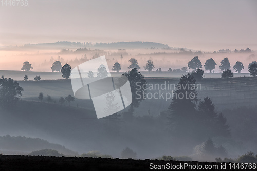 Image of Autumn foggy and misty sunrise landscape