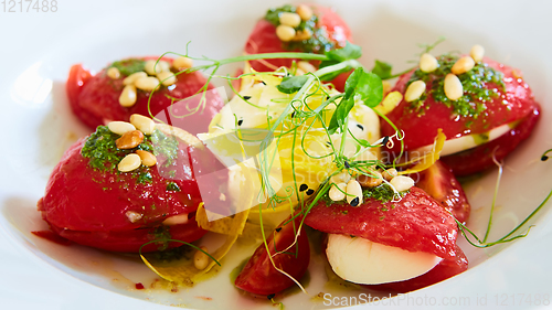 Image of Mozzarella and tomato salad - caprese on the white plate. Shallow dof