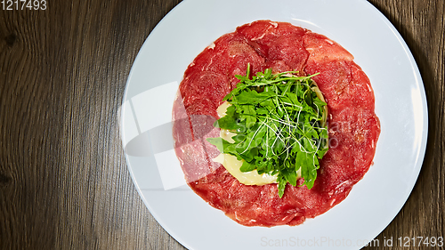 Image of The meat carpaccio with salad. Shallow dof.