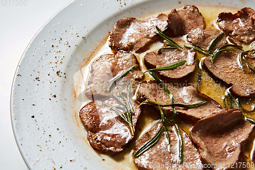 Image of Fried beef tongue with coarse salt. Grilled beef tongue.