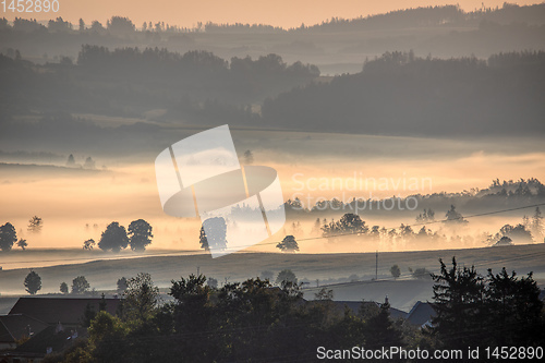 Image of Fall foggy and misty sunrise landscape