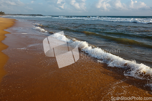 Image of Wave surging on sand