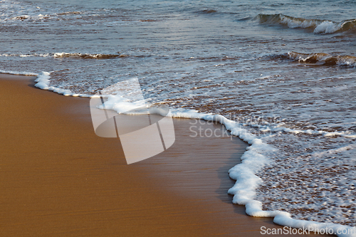 Image of Wave surging on sand