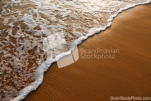 Image of Wave surging on sand