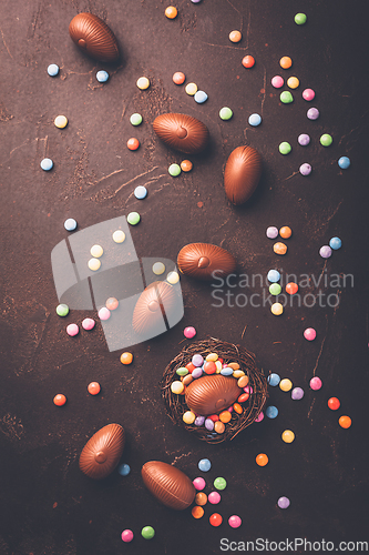 Image of Sweet Easter - Chocolate eggs and colorful chocolate beans in bird nest