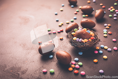 Image of Sweet Easter - Chocolate eggs and colorful chocolate beans in bird nest