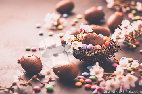 Image of Sweet Easter - Chocolate eggs and colorful chocolate beans in bird nest