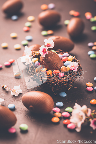 Image of Sweet Easter - Chocolate eggs and colorful chocolate beans in bird nest