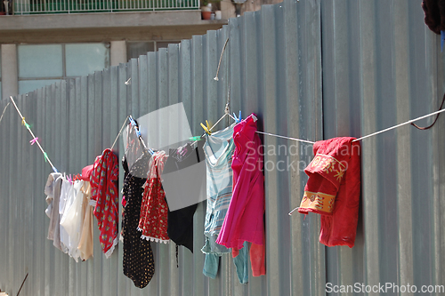 Image of laundry drying on metal fence