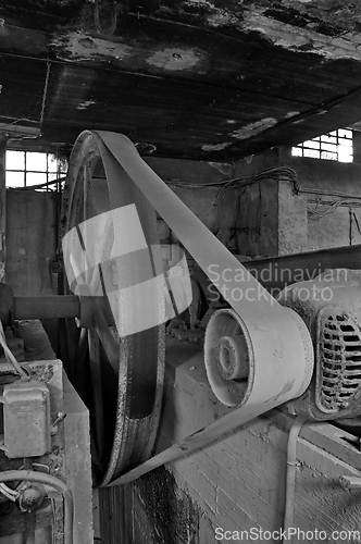 Image of belt driven machinery in abandoned factory