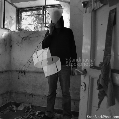 Image of man obscured by piece of broken glass