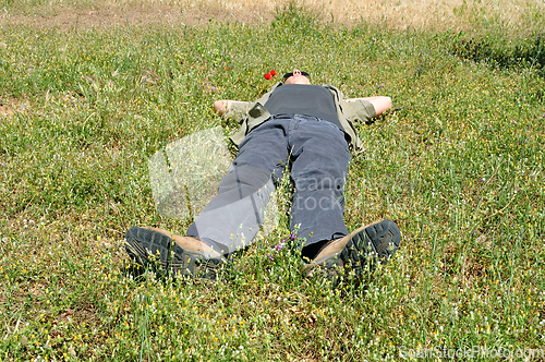 Image of man lying on grass