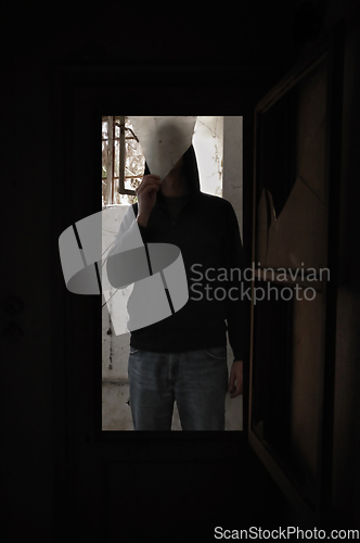 Image of man with piece of broken glass