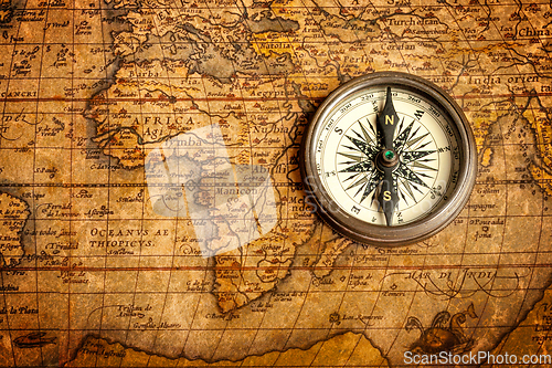 Image of Old vintage compass on ancient map