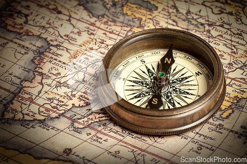 Image of Old vintage compass on ancient map