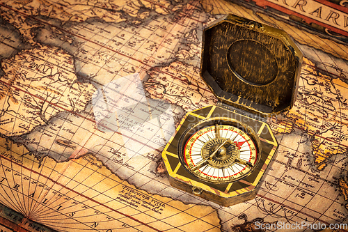 Image of Vintage pirate compass on ancient map