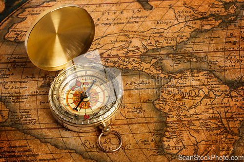 Image of Old vintage golden compass on ancient map